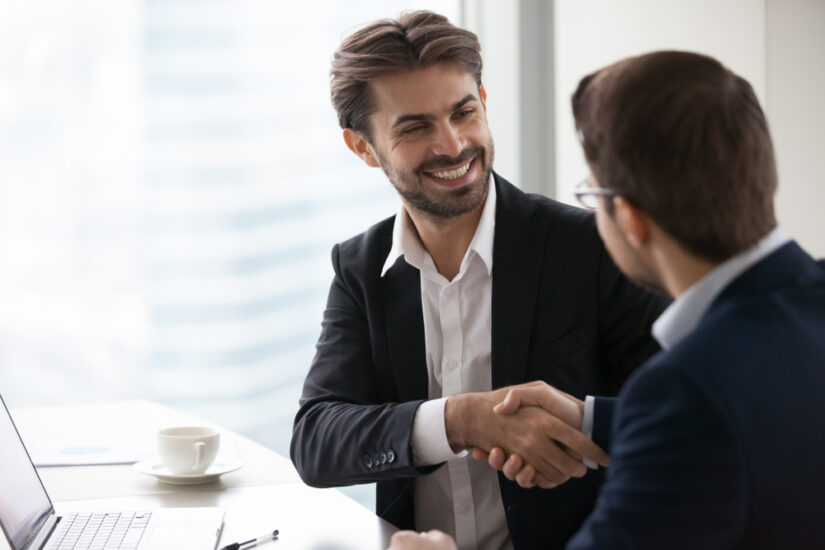 Photo of Two Men Shaking Hands